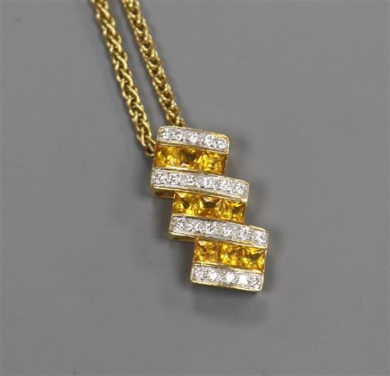 An 18ct gold and diamond pendant on an 18ct gold chain, pendant 21mm.